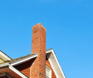 house with chimney in front of blue sky