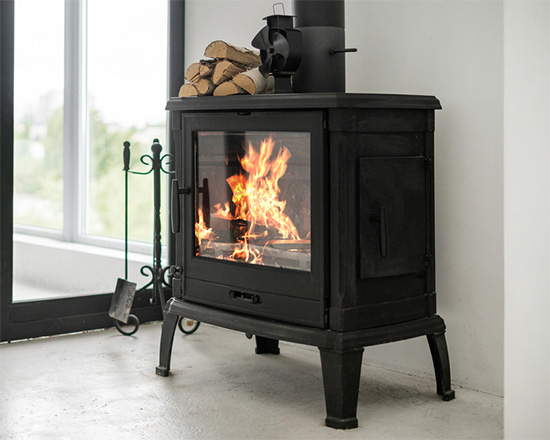 Stock Image- lit wood stove- New Buck Chimney Services