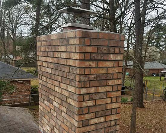 Original Image-brick chimney with silver chimney cap- New Buck Chimney Services